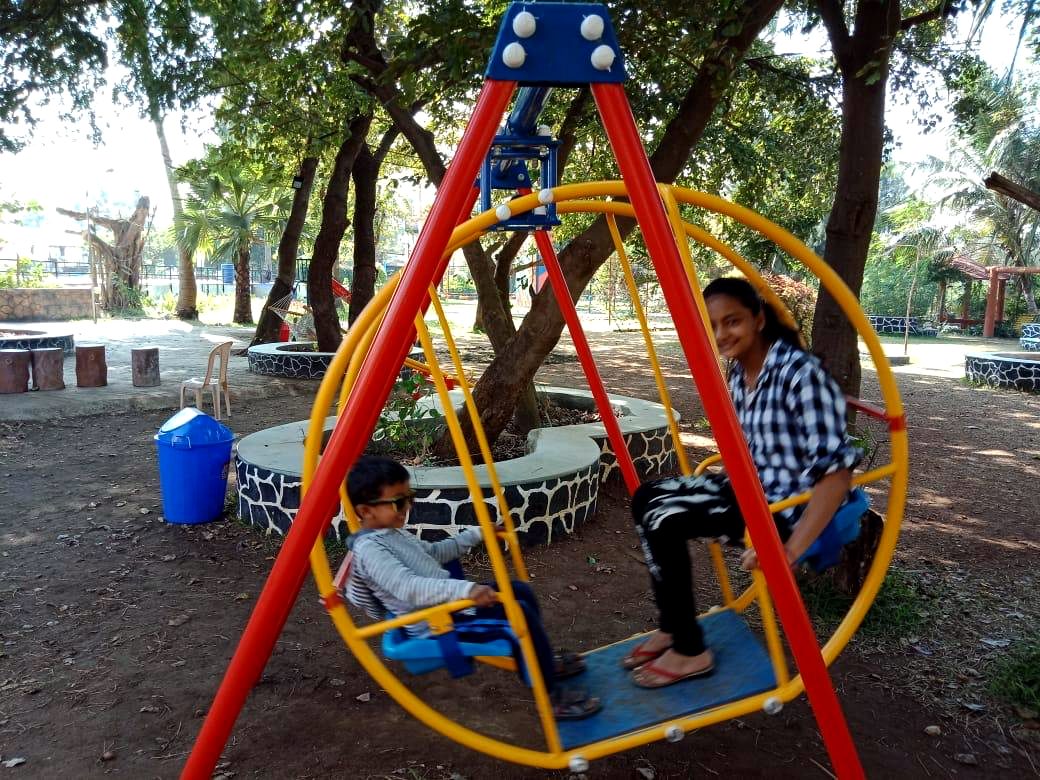 Family swing under the trees